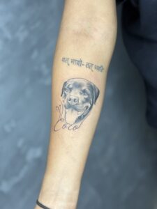 Black and grey tattoo of a dog's portrait with name lettering on forearm — 1920 Tattooz Hub, Ahmedabad