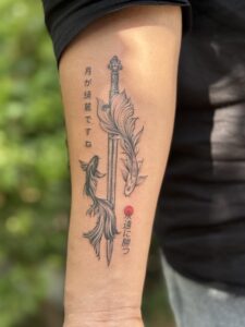 Black and grey tattoo of a Japanese sword with koi fish on forearm — 1920 Tattooz Hub, Ahmedabad