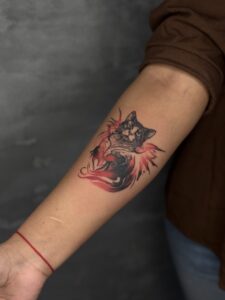 Colored tattoo of a cat portrait on forearm — 1920 Tattooz Hub, Ahmedabad