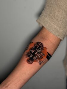 Colored tattoo of a Hindi quote in watercolor style on forearm — 1920 Tattooz Hub, Ahmedabad