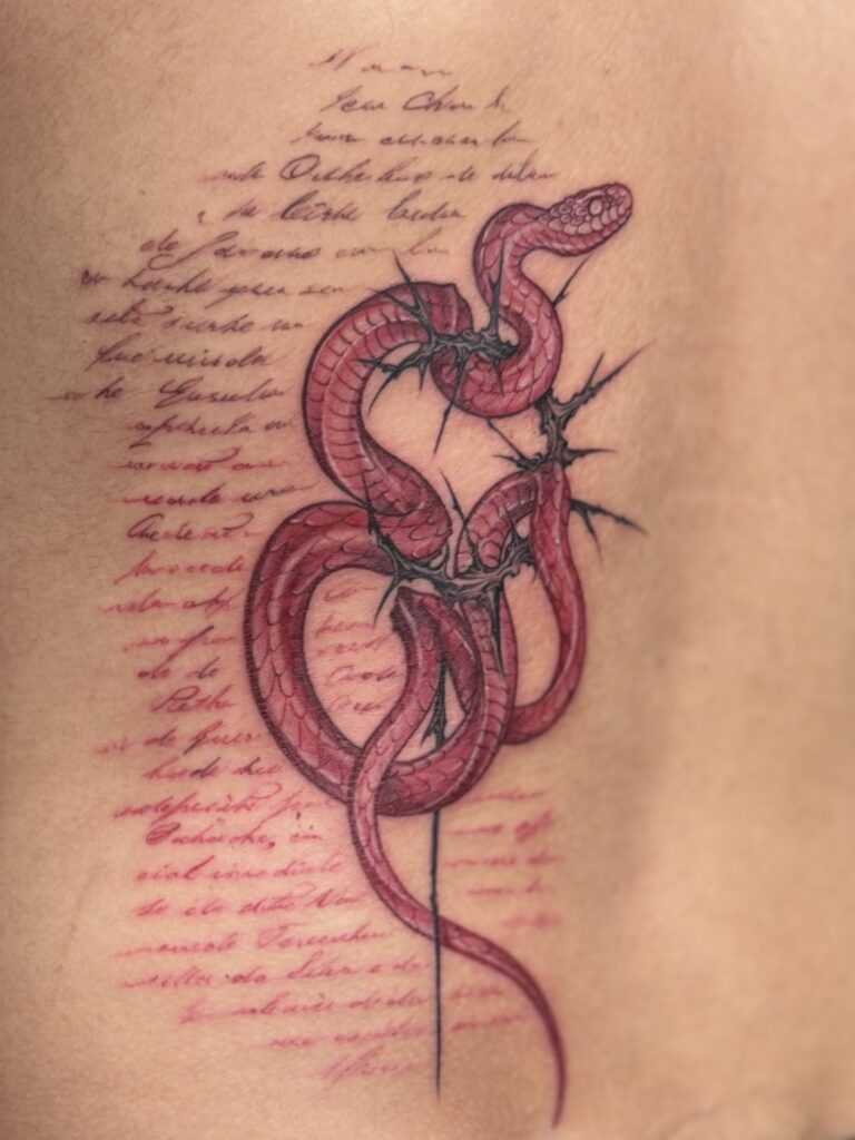 Colored tattoo of a snake wrapped in thorns on ribs — 1920 Tattooz Hub, Ahmedabad