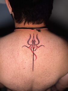 Colored tattoo of a trishul on upper back — 1920 Tattooz Hub, Ahmedabad
