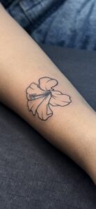 Fine line tattoo of a hibiscus flower on forearm — 1920 Tattooz Hub, Ahmedabad