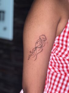 Fine line tattoo of a jellyfish on upper arm — 1920 Tattooz Hub, Ahmedabad