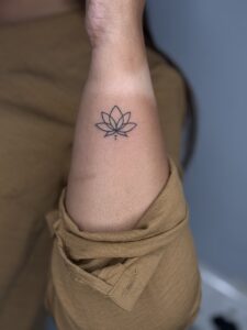 Fine line tattoo of a lotus flower on ankle — 1920 Tattooz Hub, Ahmedabad