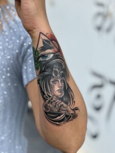 Realistic tattoo of an Egyptian queen with the Eye of Horus on bicep — 1920 Tattooz Hub, Ahmedabad