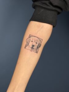 Realistic tattoo of a golden retriever puppy on forearm — 1920 Tattooz Hub, Ahmedabad