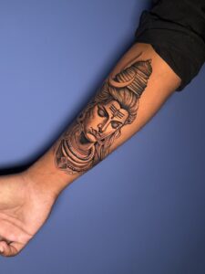Realistic tattoo of Lord Shiva's face in meditation on forearm — 1920 Tattooz Hub, Ahmedabad