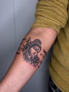Realistic tattoo of Lord Shiva with a trishul above his head on forearm — 1920 Tattooz Hub, Ahmedabad