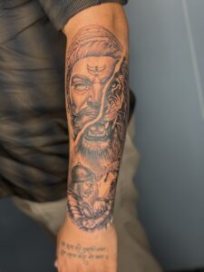 Realistic tattoo of a warrior's face morphing into a lion on forearm — 1920 Tattooz Hub, Ahmedabad