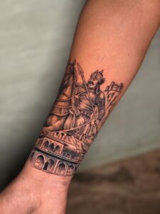 Realistic tattoo of a warrior king on horseback with a fort on forearm — 1920 Tattooz Hub, Ahmedabad